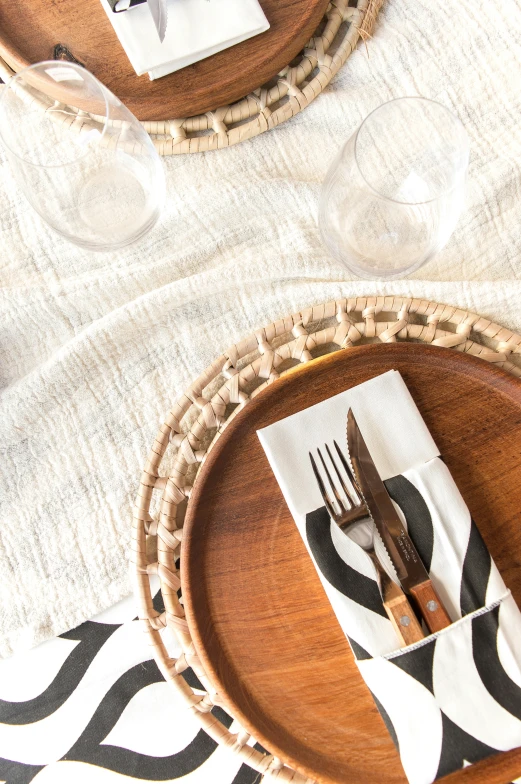 wooden utensils on a serving tray with white linen