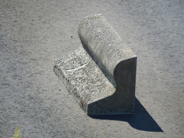 a rolled up object laying on a cement surface