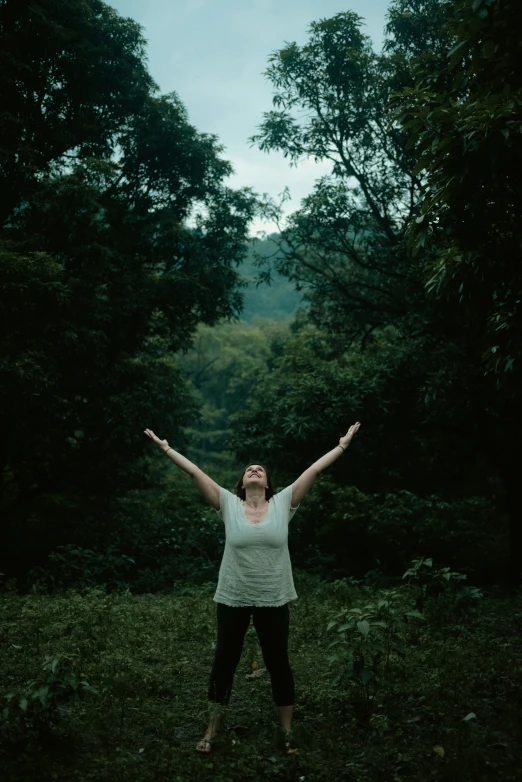 the woman has her arms open in the field