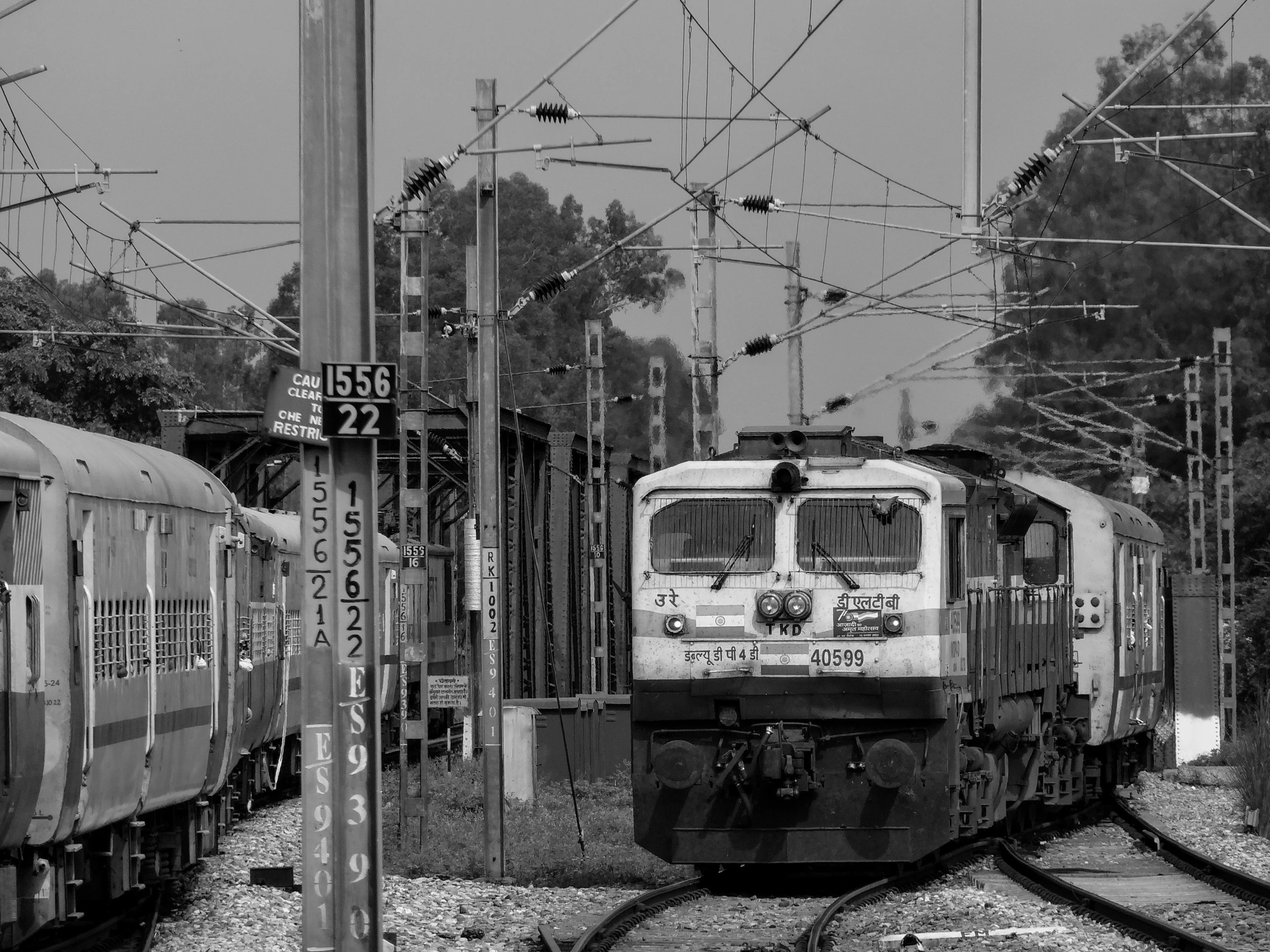 some trains are going by in a black and white po