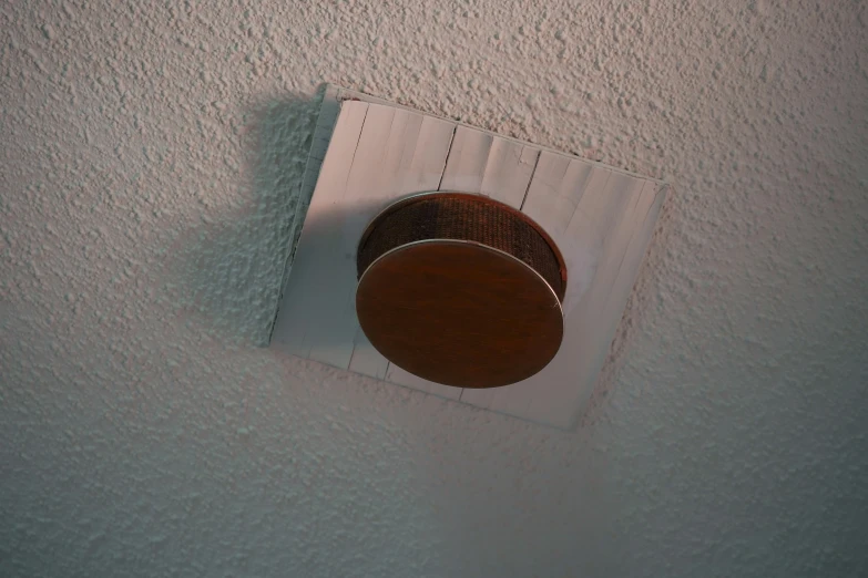 a white ceiling fan sitting inside of a bathroom