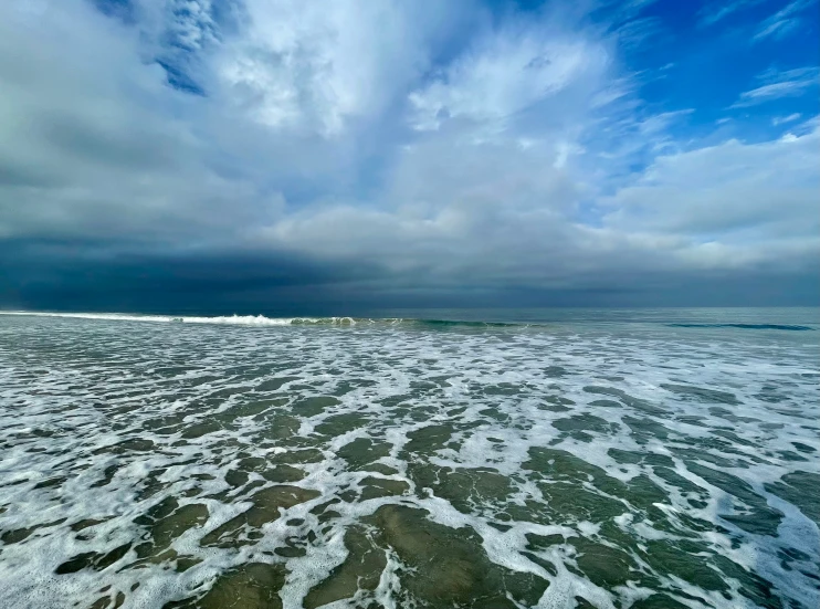 the water is green as it moves toward shore