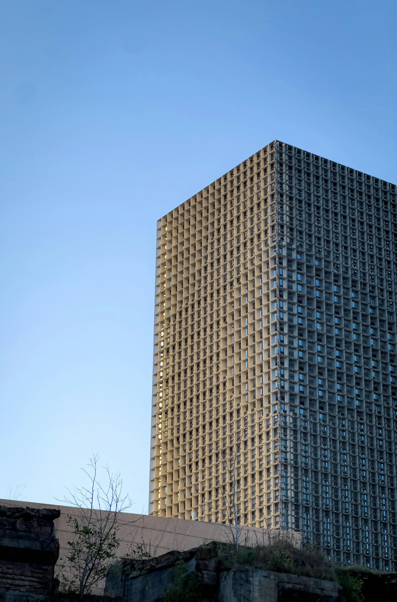 a very tall building in front of a blue sky