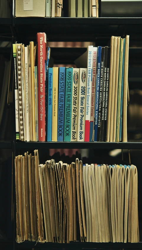 a book shelf with books, magazines and more