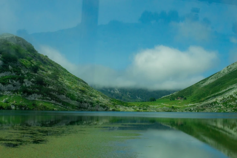 an image of a beautiful lake with trees and mountains in the background