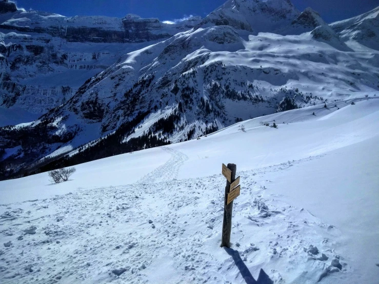 there is a trail in the middle of a snowy mountain