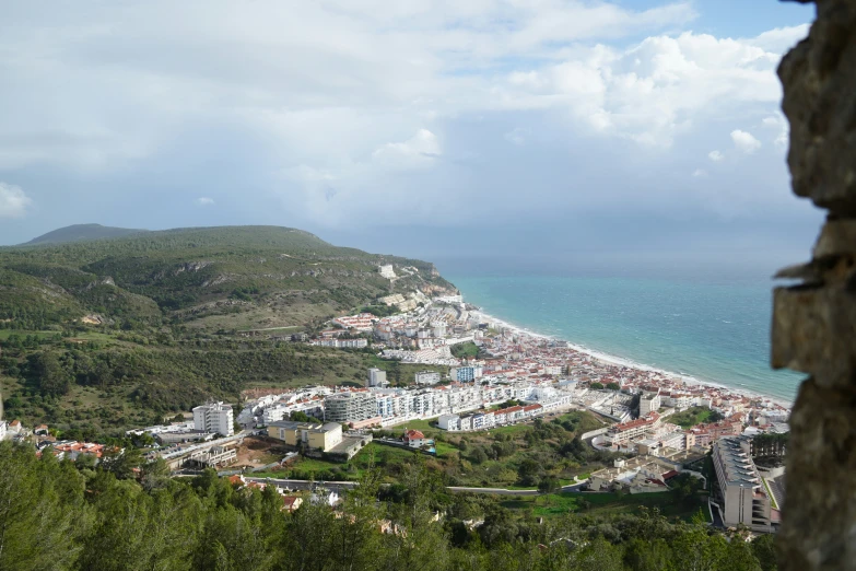 a town is nestled on a mountain overlooking the ocean