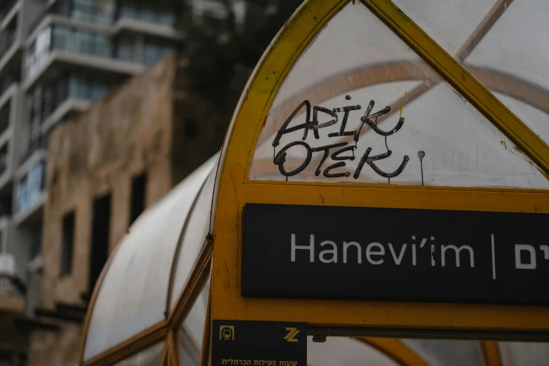 the word hanevn'm'er on the side of an open bus stop