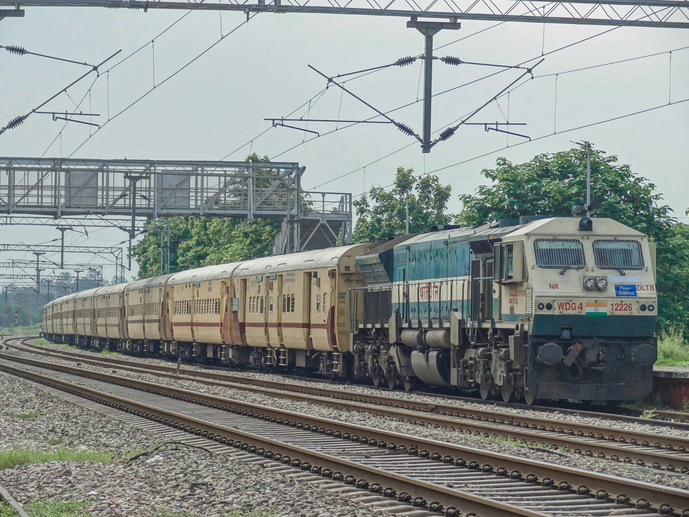 a train is traveling through the countryside on an overpass