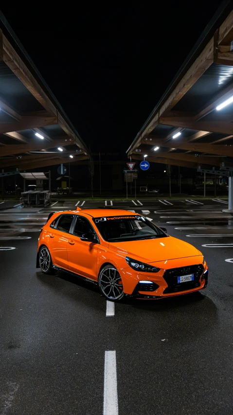 a bright orange car is parked in an intersection