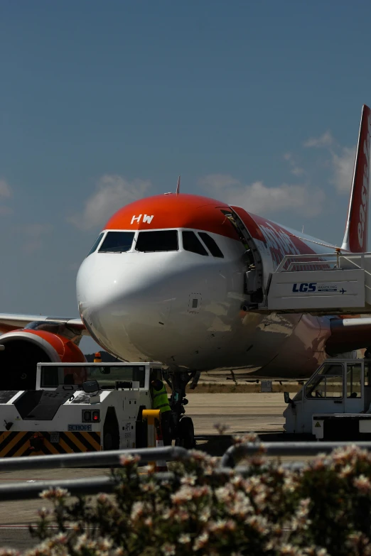 an airplane that has a bunch of lift trucks attached