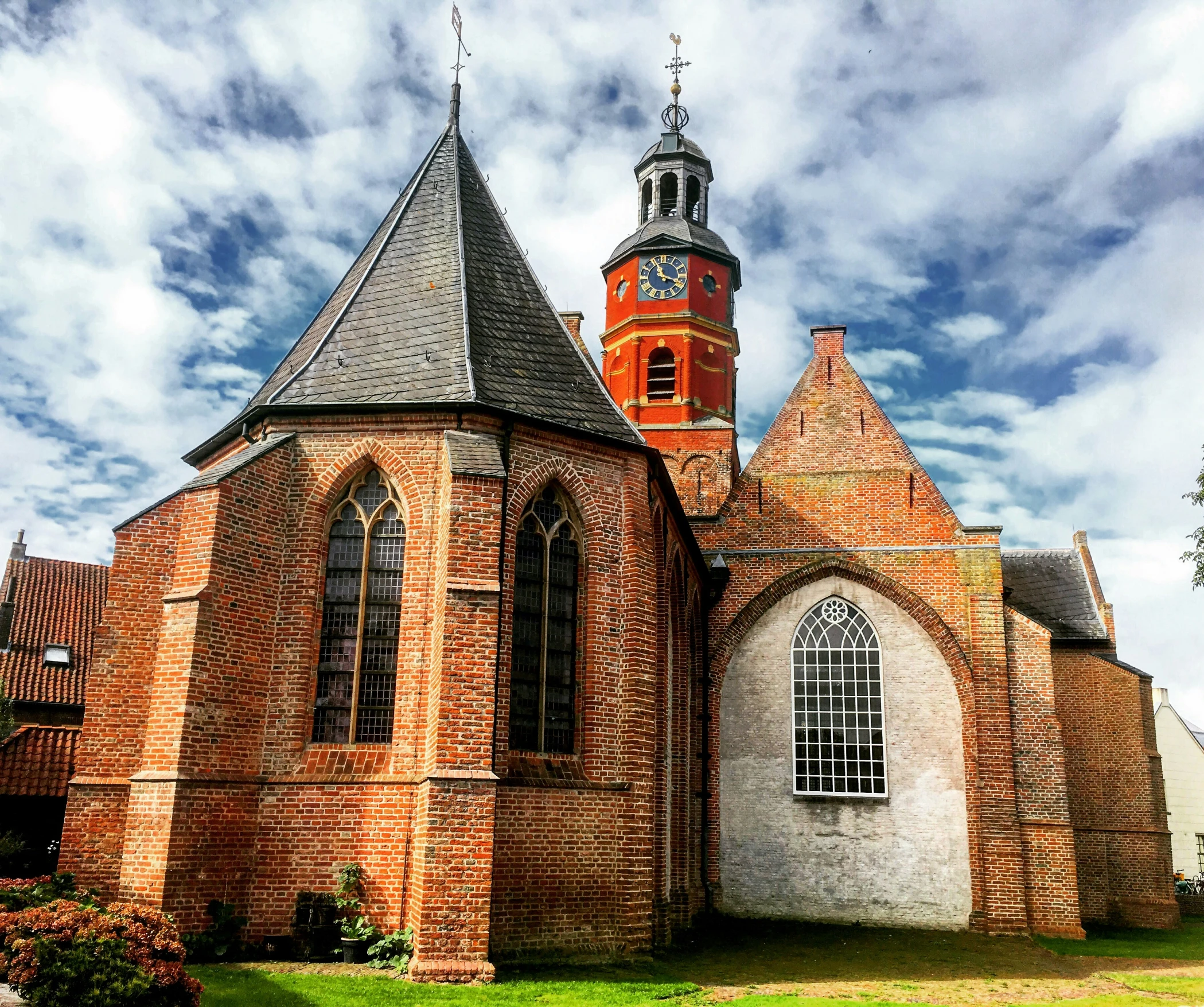 the front view of an old church with the tower at the top and clock on the clocktower