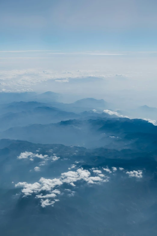 a very cloudy sky is seen over the mountains