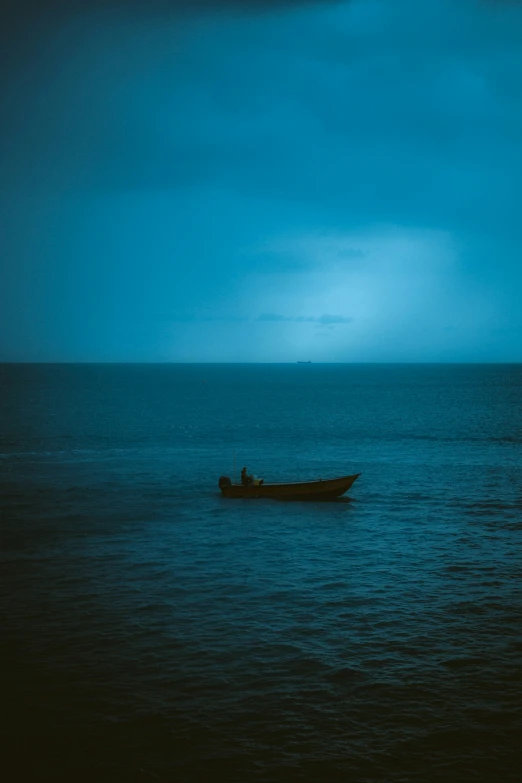 a boat is in the water on a very cloudy day