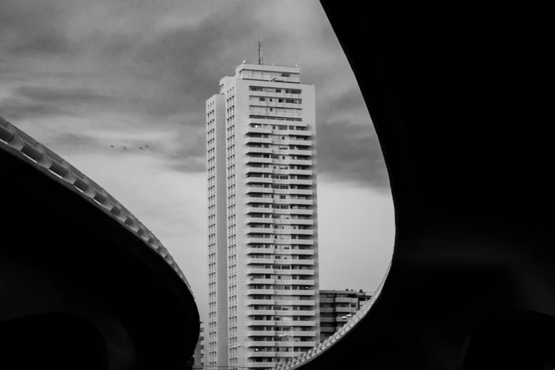 looking through the arch at a tall building