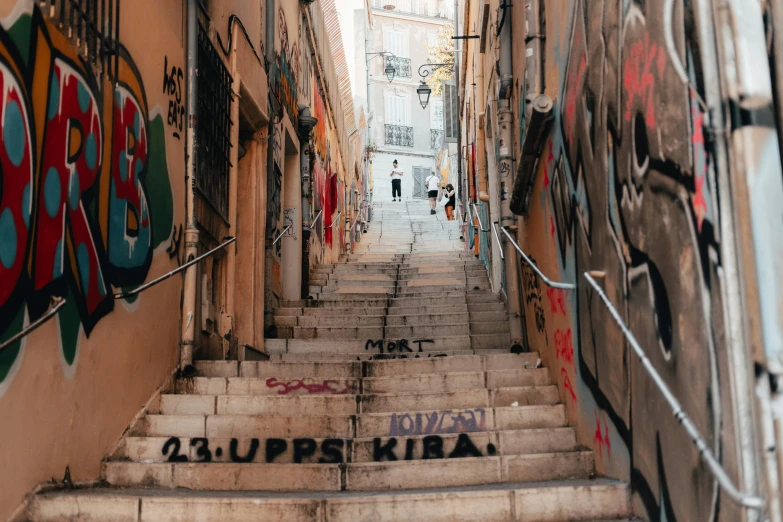 graffiti on the stairs and steps of a narrow alleyway