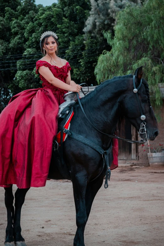 a woman is sitting on a horse and posing for the camera