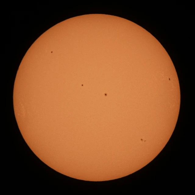 an airplane is flying through front of a sun