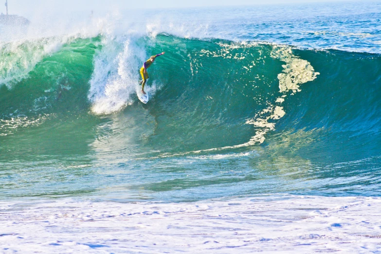 person riding a wave on top of surf board