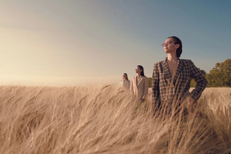 three people are standing in a field