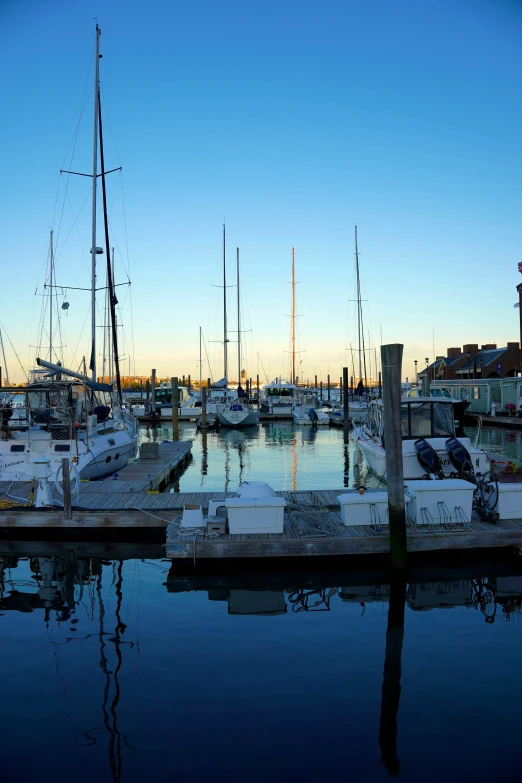 a marina filled with lots of sailboats on top of water