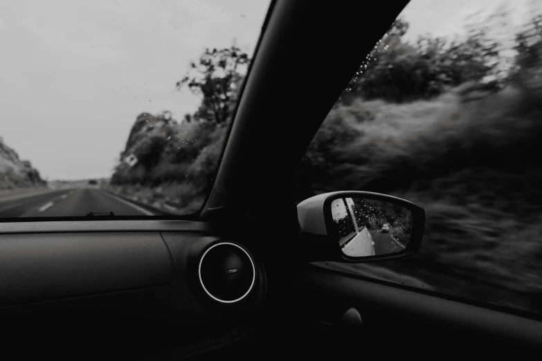 a black and white po of a man in a car driving