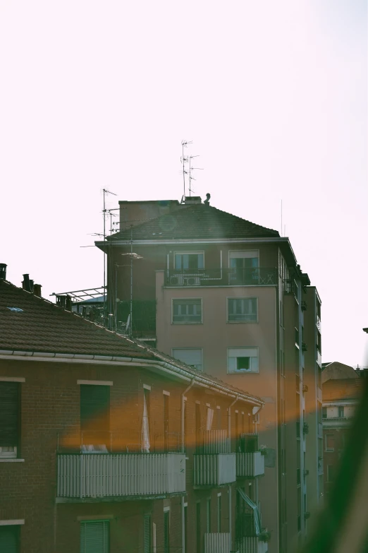 an apartment building with a clock tower in the middle