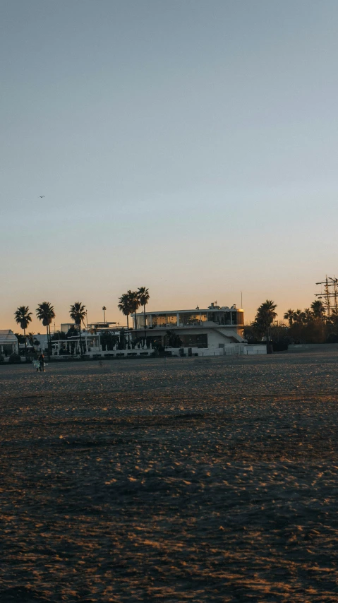 a person walking down the beach flying a kite