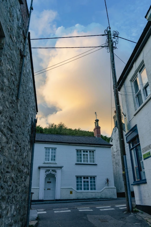 two buildings next to each other with clouds in the sky