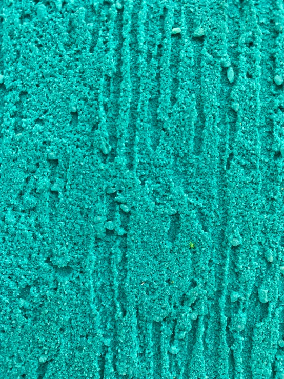 the blue textured surface of the concrete wall