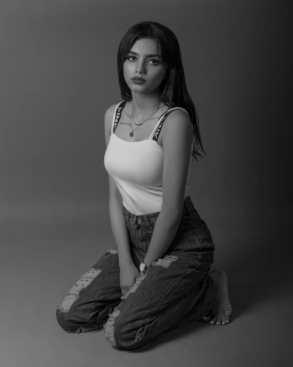 a woman with long hair wearing a tank top