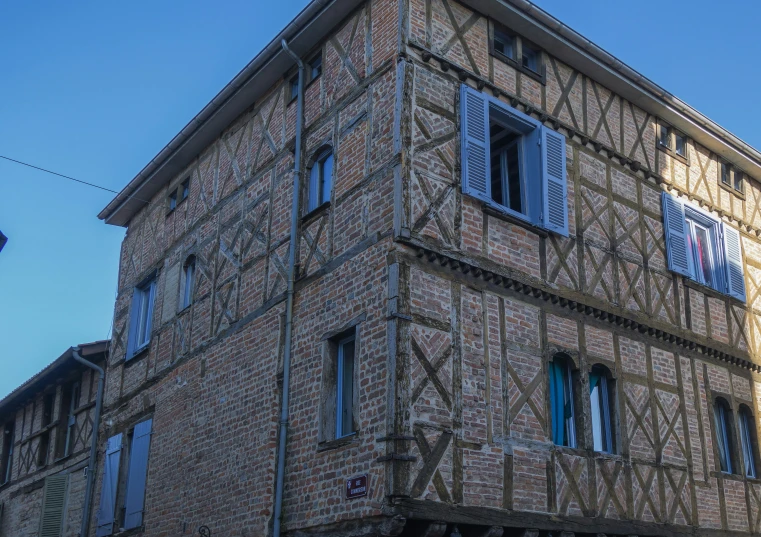 a tall brick building with windows on each of the sides