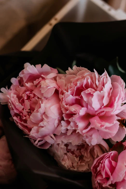 a large pink flower sits in a bunch of other flowers