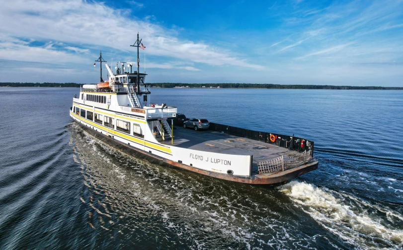 an ferry on the water, with the crew getting ready to leave