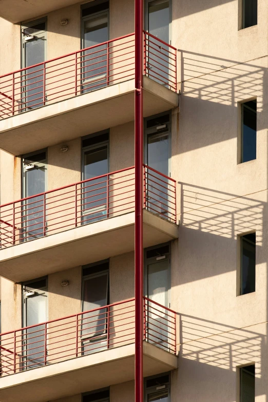 the top of an apartment building with balconies and metal railings