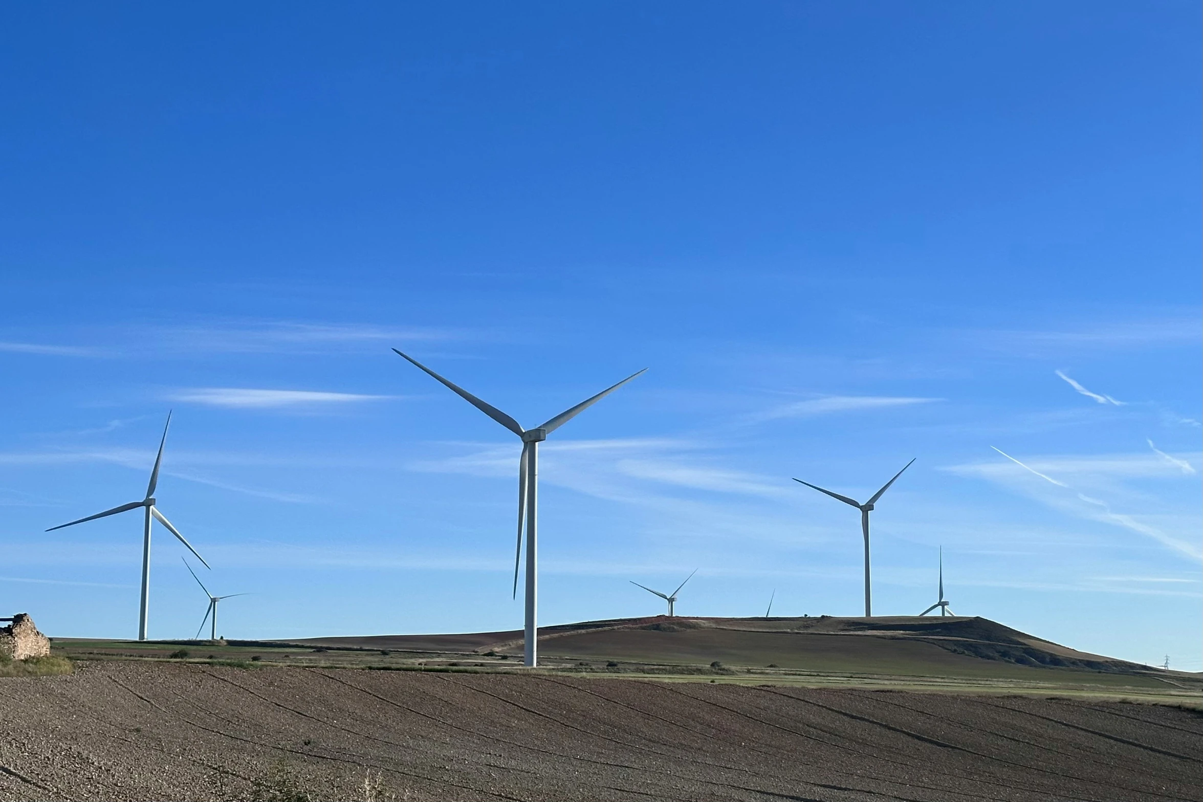 a group of windmills that are sitting on top of a hill