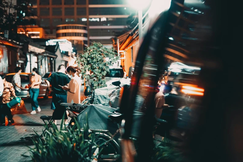 people walk past cars at a busy street