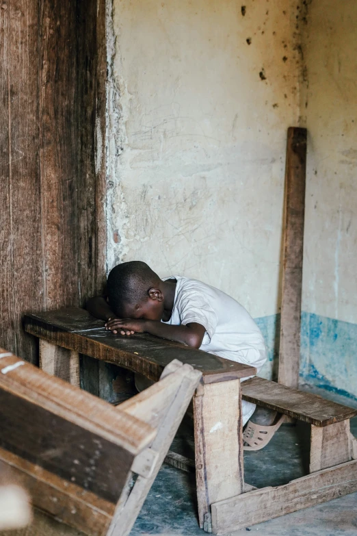 a person sleeping on a bench in a room