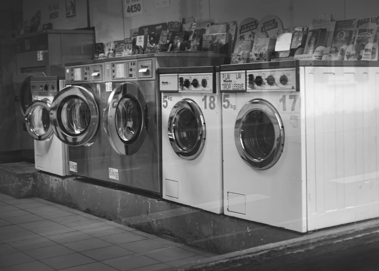 some washers and dryers sitting in a row