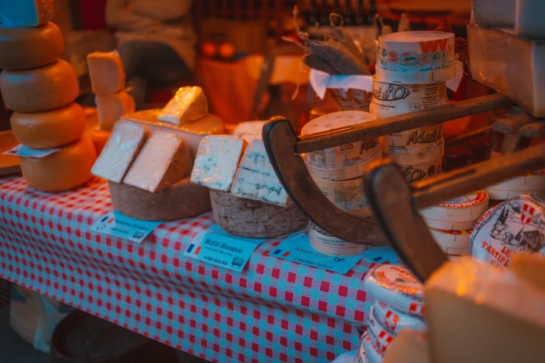 cheese and bread on display for sale in a market