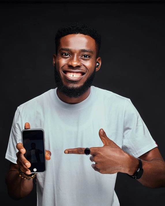 black man holding a mobile phone in front of his face