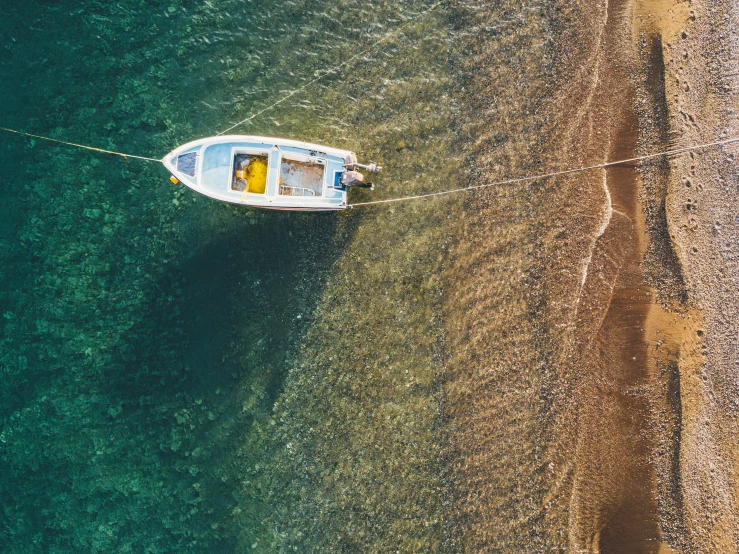 a small boat on a clear blue lake