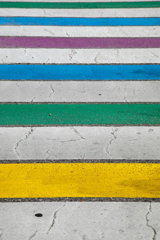 an open air parking lot with rainbow painted lines