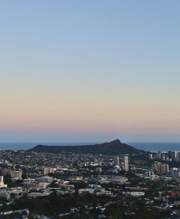 the large city has tall buildings in front of a mountain