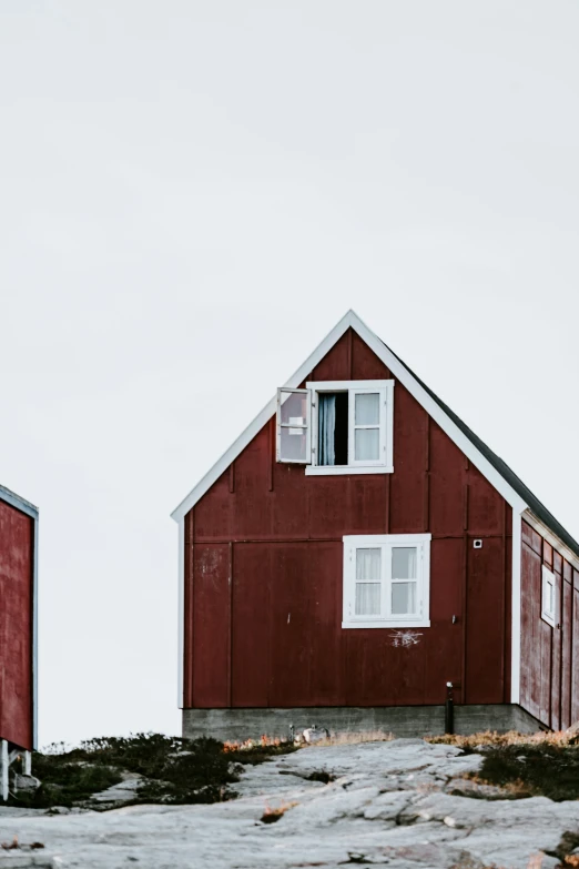 red two story building on the side of a small hill