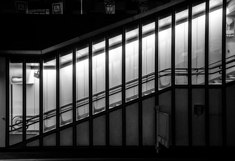 a black and white picture of an escalator
