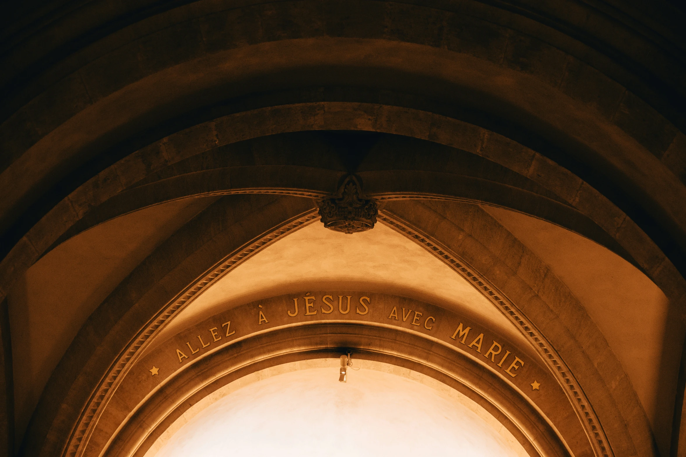 view from beneath of the arches and ceiling with a clock