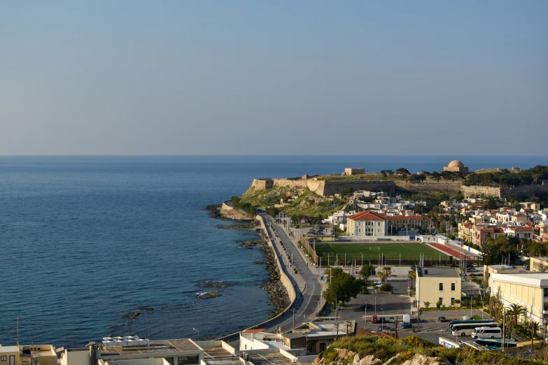 a long stretch of road on the side of an ocean