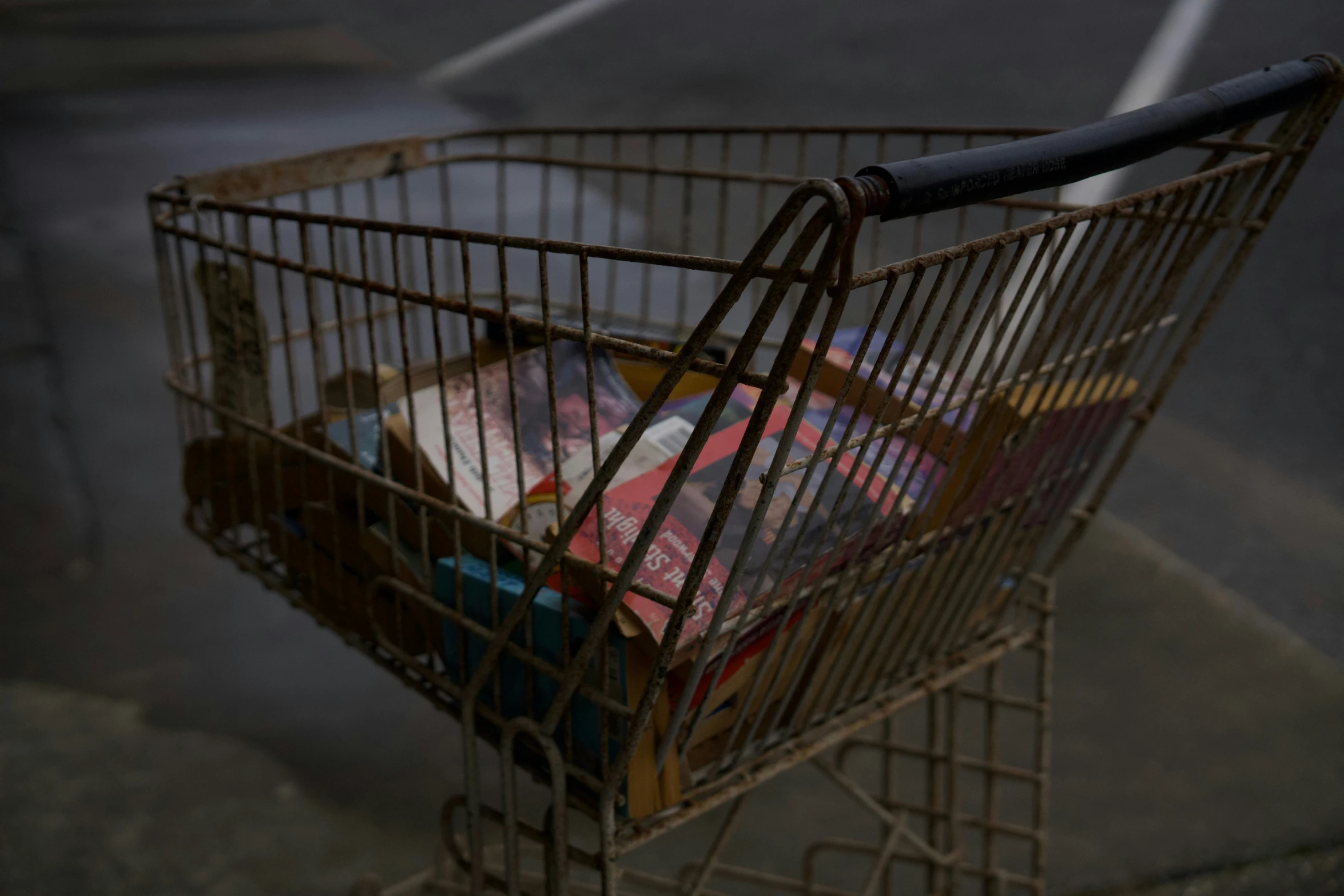 a shopping cart is parked on the side of the road