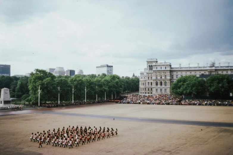 a group of people standing around in a courtyard in front of a large building